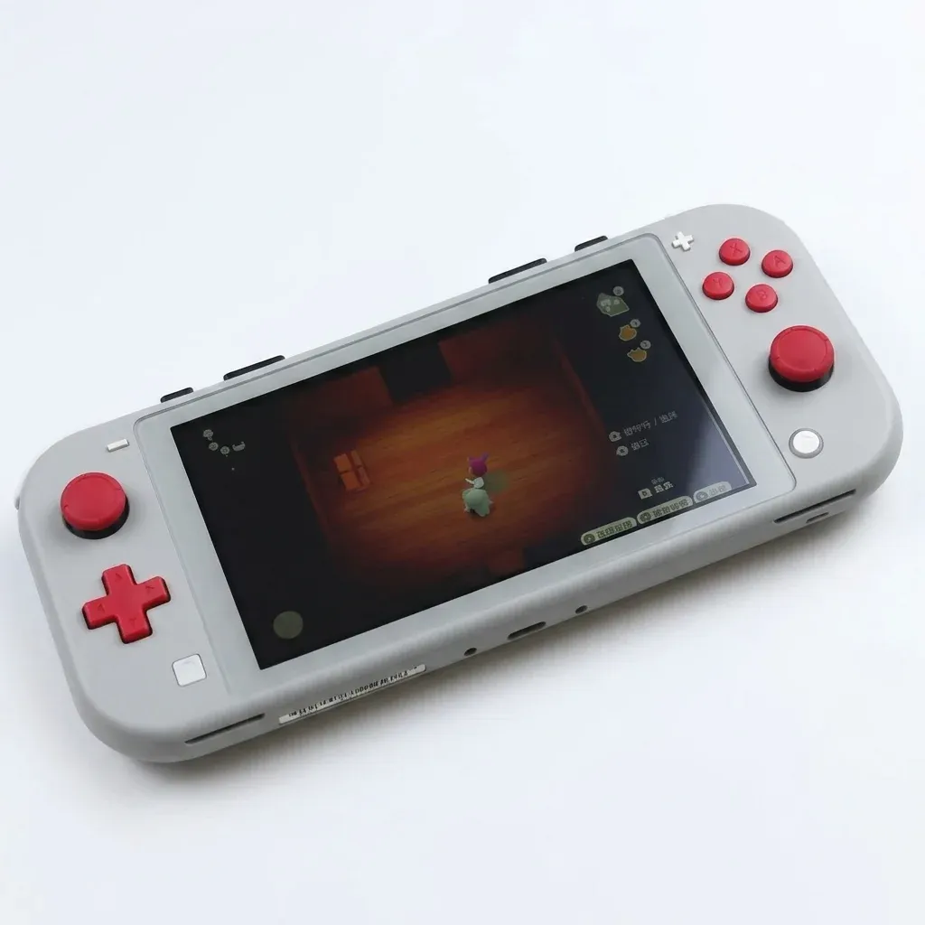 Light gray handheld gaming console with red buttons